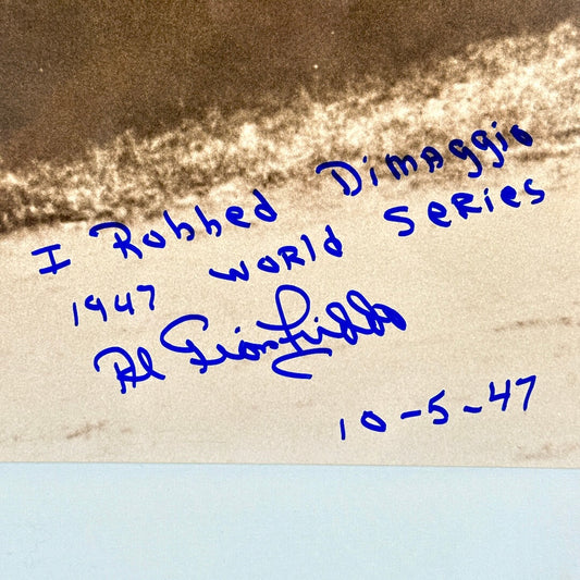 Text in blue ink on a textured background, a signature and inscription.