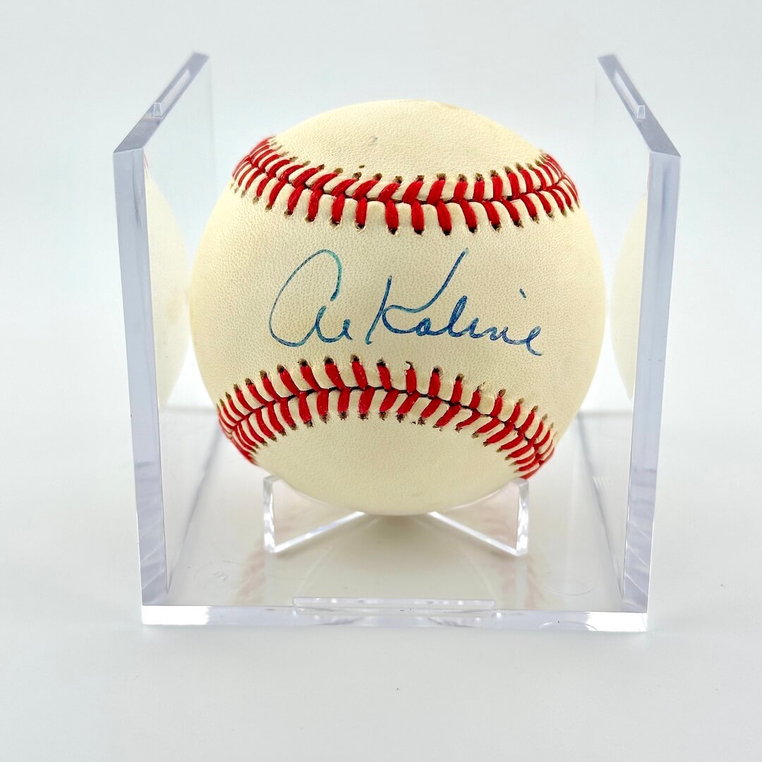 Signed baseball in clear display against white background.