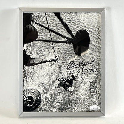 Framed black and white photo of water recovery of Alan Shepard from landing craft. Signed in black marker. Authentication sticker in corner. 