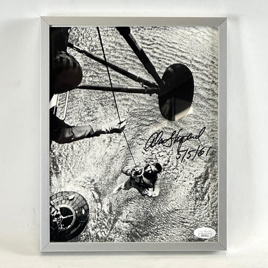 Framed black and white photo of water recovery of Alan Shepard from landing craft. Signed in black marker. Authentication sticker in corner. 