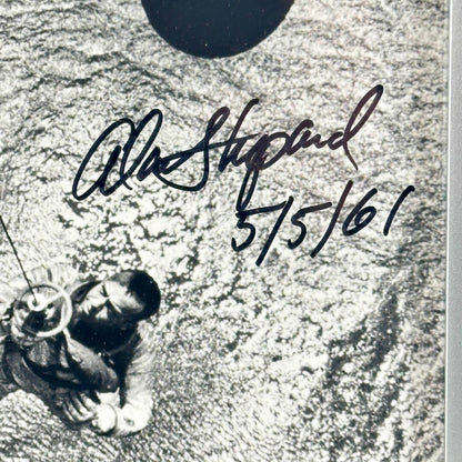 Close-up of signature and inscription next to image of person being hauled up out of the water. 