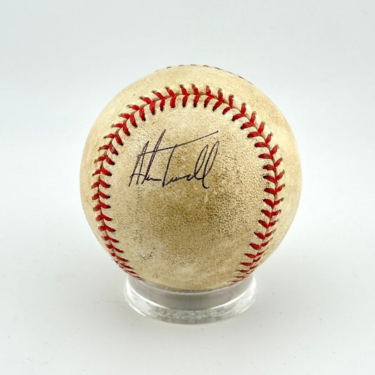 Baseball with red stitching and a signature on a white background