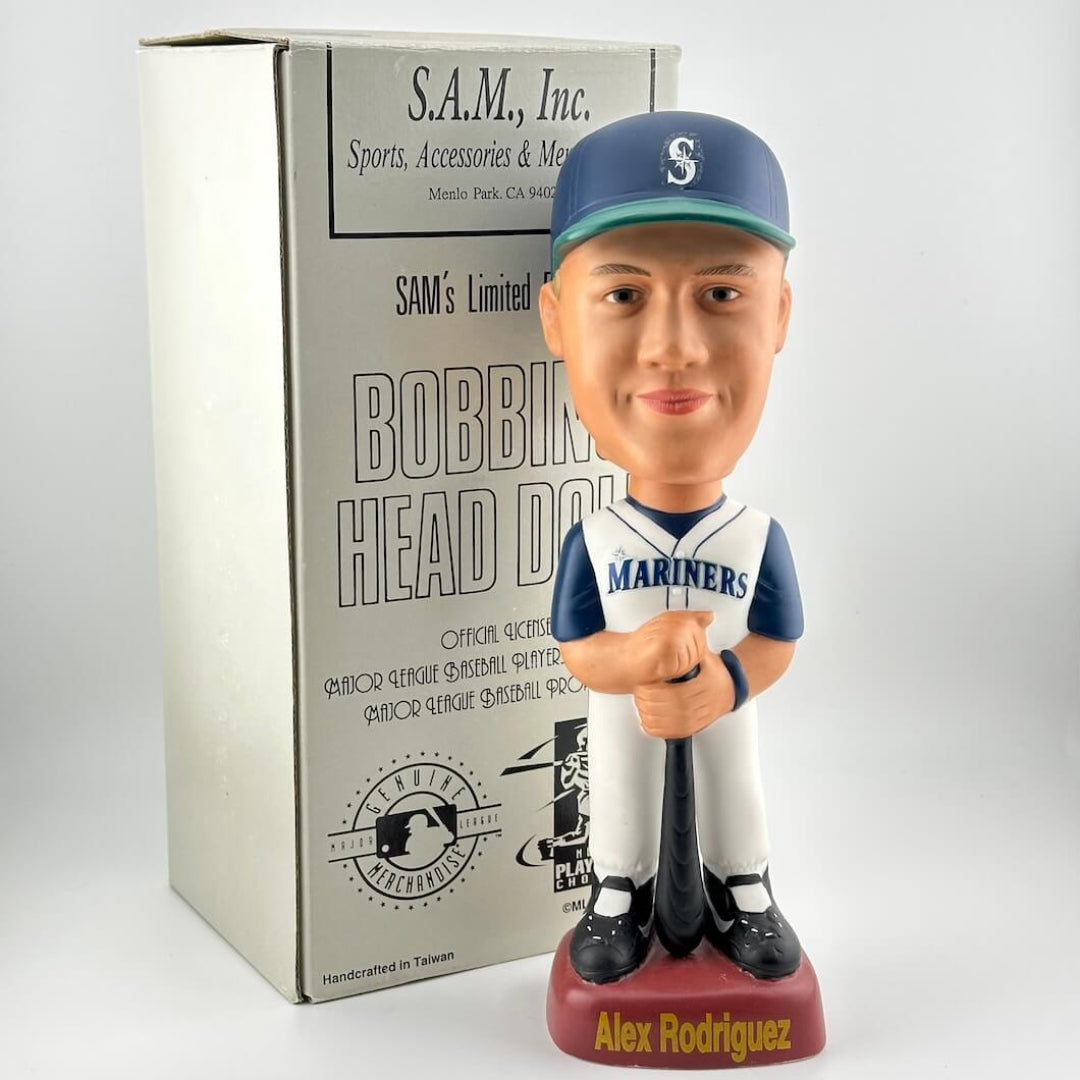 Bobblehead figure of a baseball player in a Mariners uniform with packaging in the background.