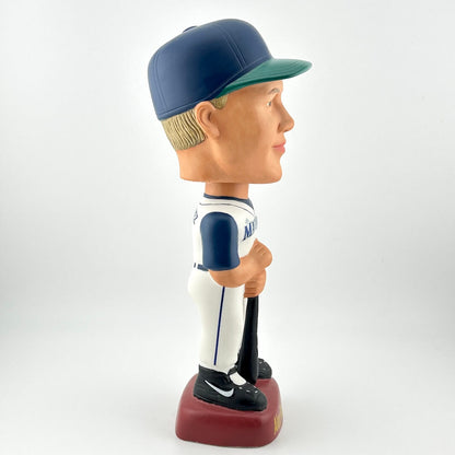 Bobblehead of a baseball player in a blue and white uniform with a cap on a white background
