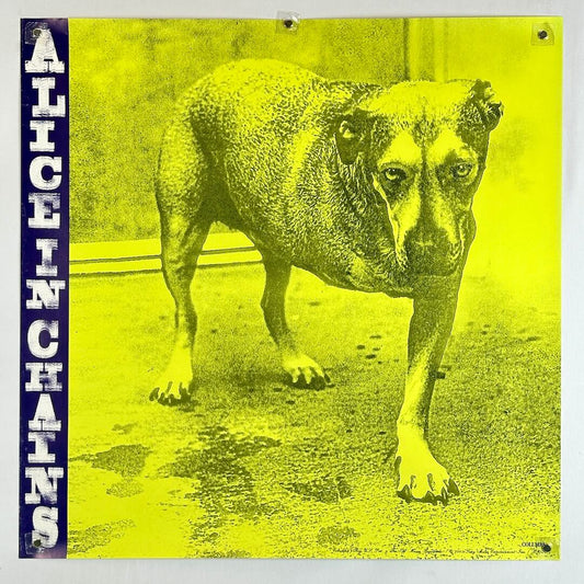 Album cover for 'Alice in Chains' with a dog and yellow background