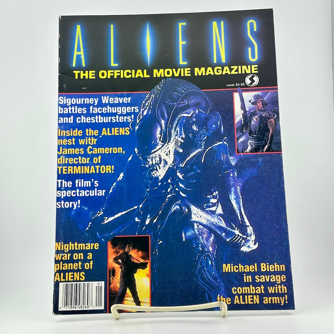 Magazine cover titled 'ALIENS: The Official Movie Magazine' featuring an alien and movie text.