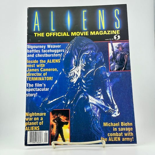 Magazine cover titled 'ALIENS: The Official Movie Magazine' featuring an alien and movie text.