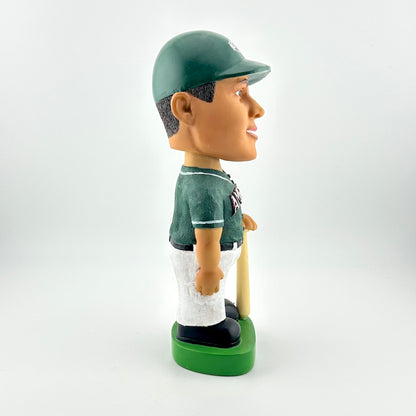 Bobblehead figure of a baseball player in a green uniform with a bat on a white background