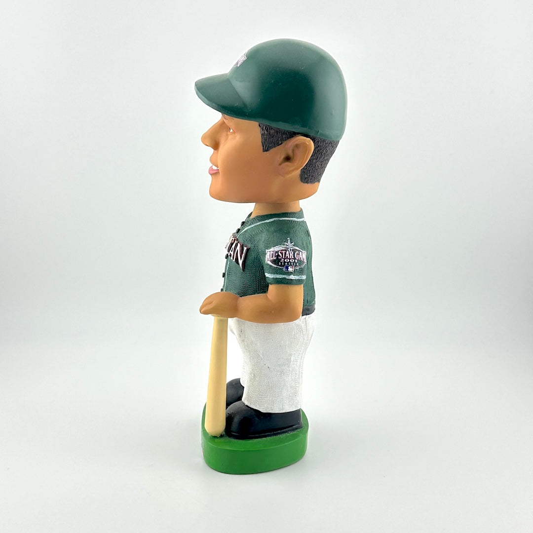 Bobblehead figure of a baseball player in a green uniform with a bat on a white background