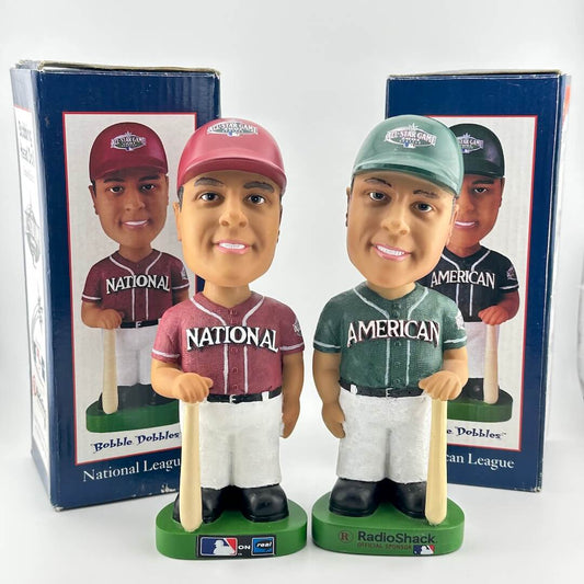 Two bobblehead figures of baseball players, one from National League and one from American League, with their packaging.