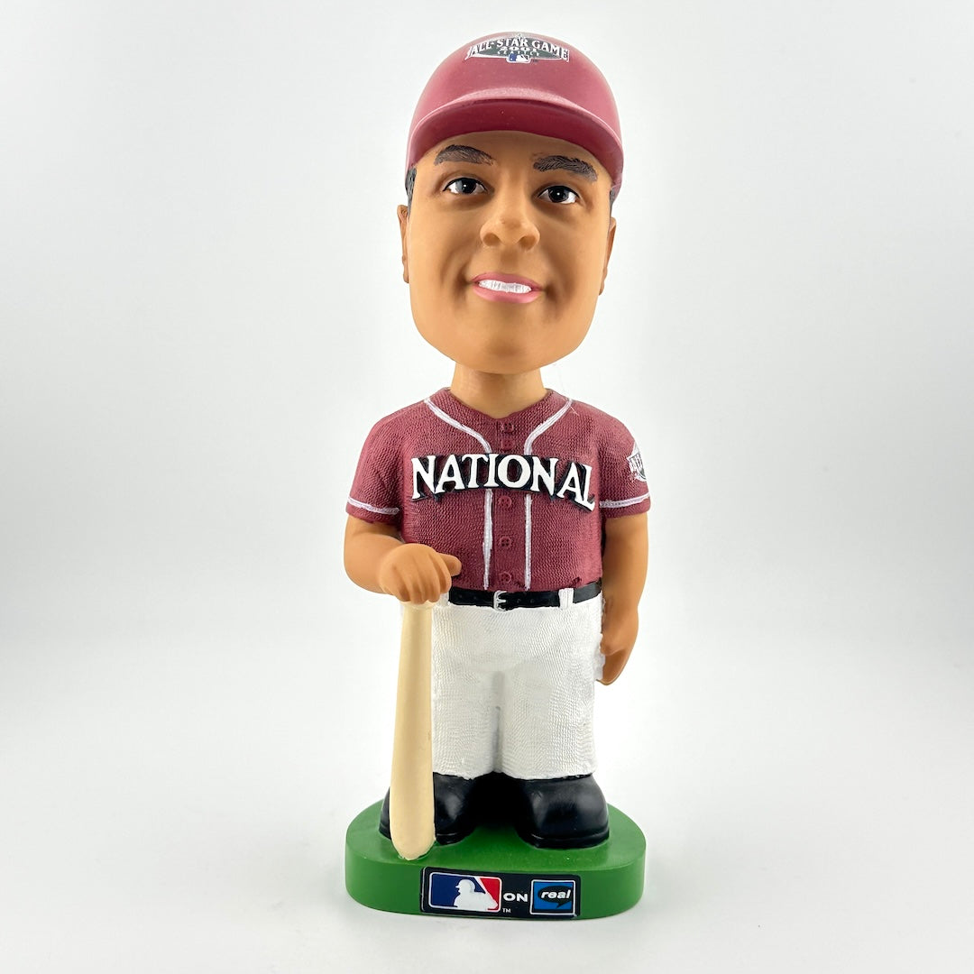 Bobblehead figure of a baseball player in a maroon and white uniform with a bat on a white background