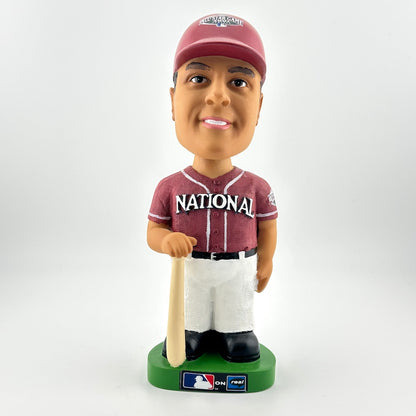 Bobblehead figure of a baseball player in a maroon and white uniform with a bat on a white background