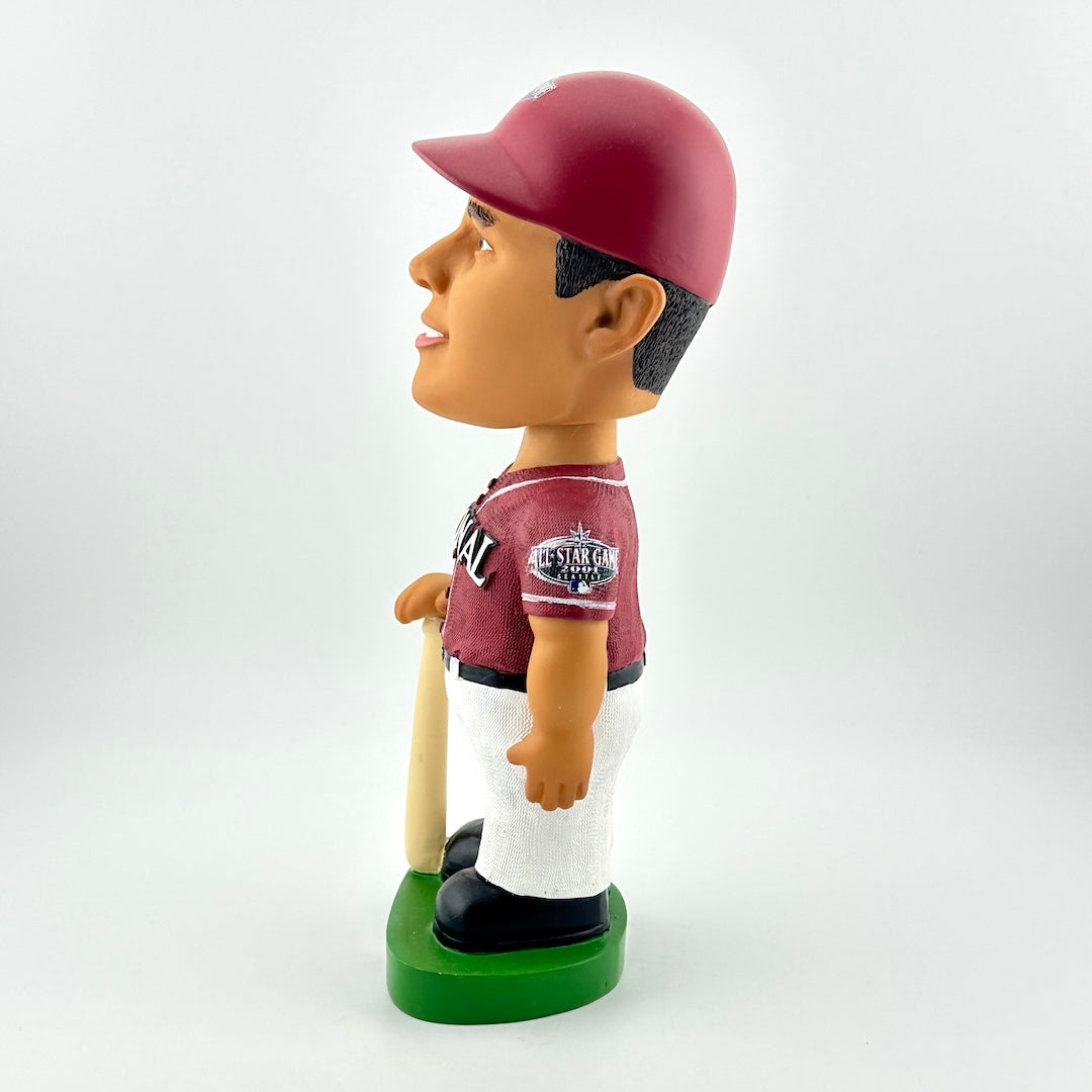 Bobblehead figure of a baseball player in a maroon and white uniform with a red cap on a white background.