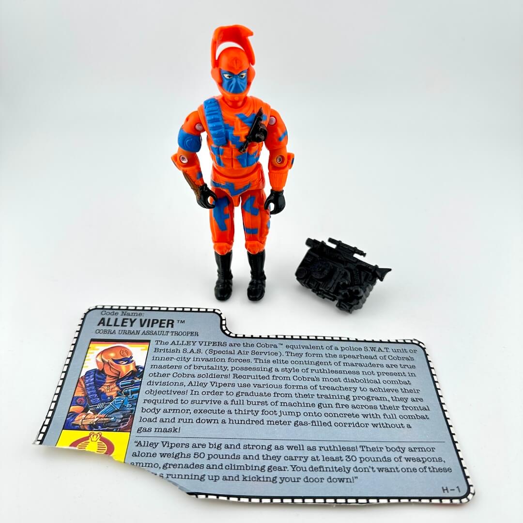 Toy figure in orange and blue costume with accessories on a white background