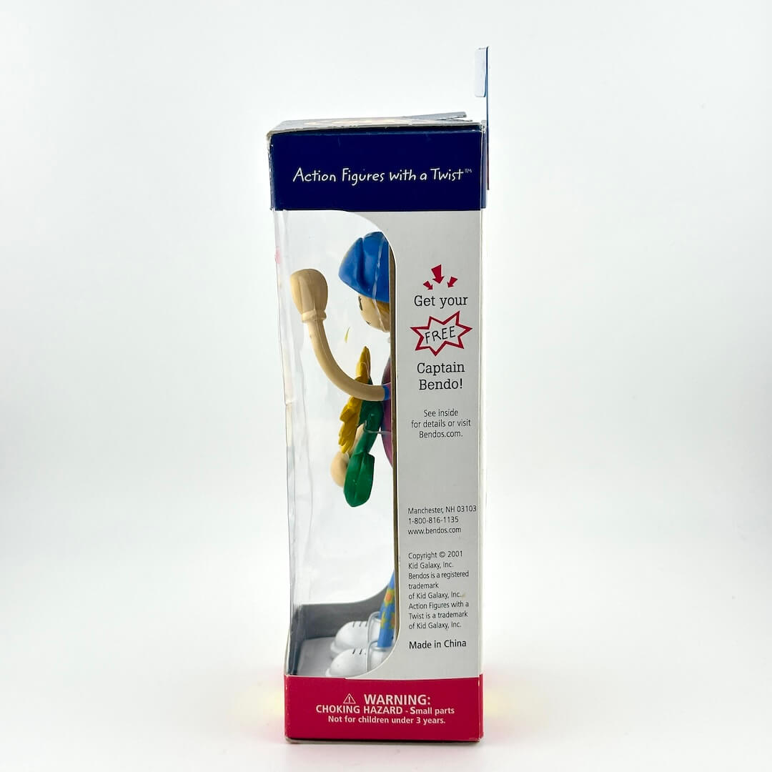 Toy figure in a clear packaging box with branding on a white background
