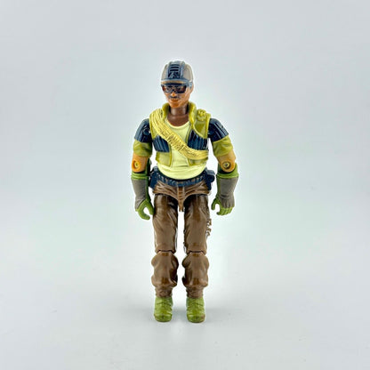 A vintage action figure of a soldier wearing a brown hat, black and green tactical vest, brown pants, and green boots.