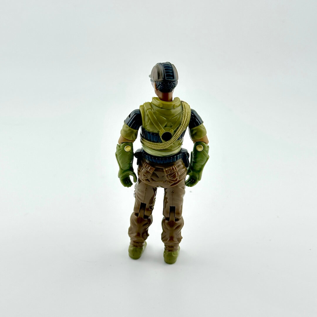 Toy figure in green and brown outfit on a white background