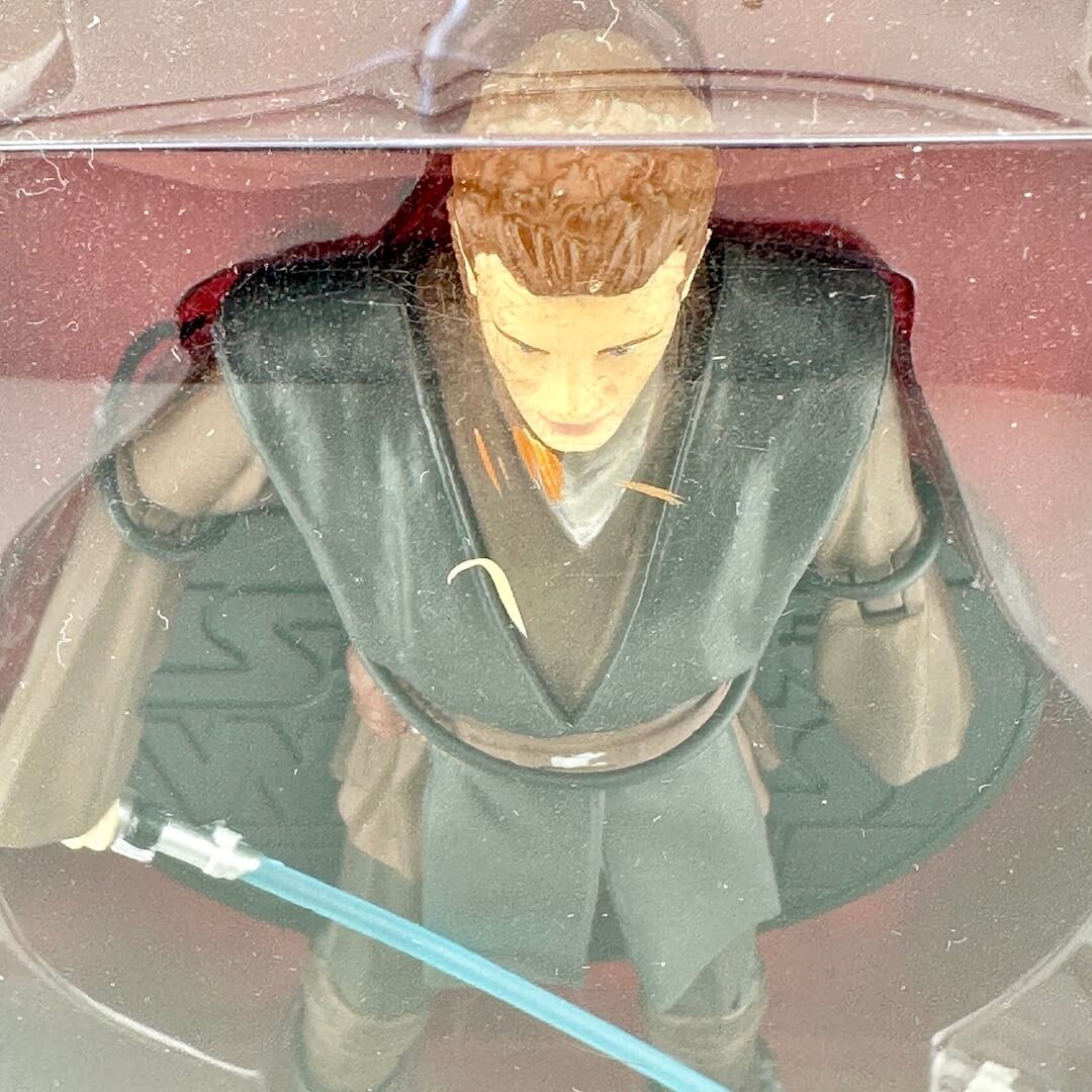 A close-up of a Star Wars action figure of Anakin Skywalker inside its clear plastic packaging.