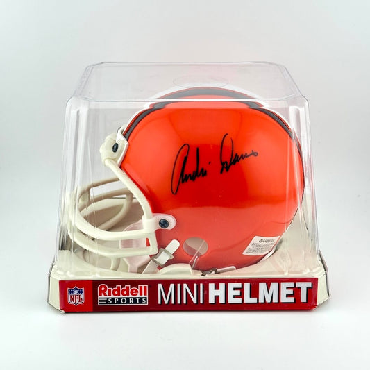 Orange mini football helmet in clear packaging with 'Riddell' branding on a white background