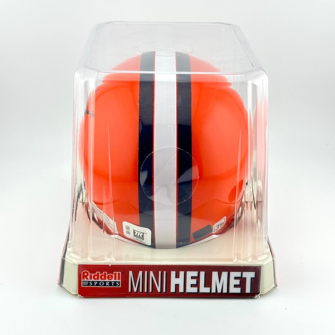 Orange mini football helmet with black and white stripes in clear packaging, featuring Riddell Sports branding.