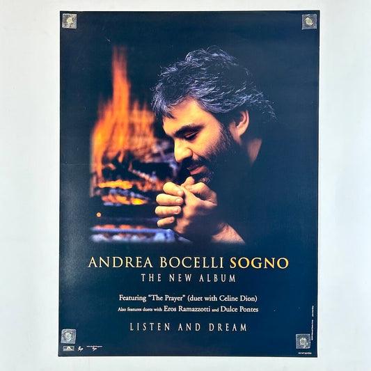 Andrea Bocelli album cover poster with a man holding his hands together in front of a fireplace.