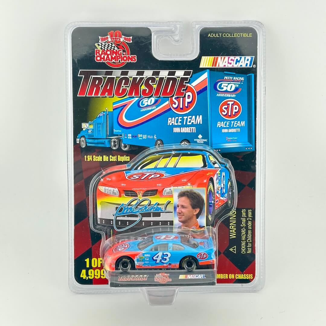 John Andretti's #43 STP Pontiac Grand Prix  diecast car in its original retail packaging against a light gray background. 