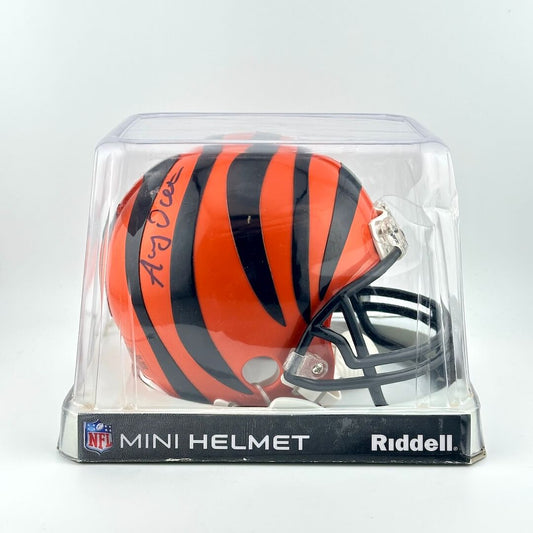 Riddell mini football helmet in packaging with orange and black stripes on a white background