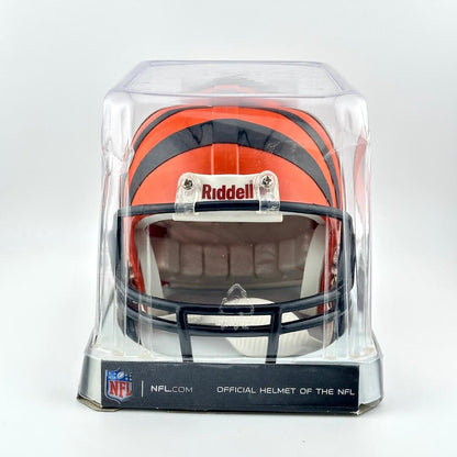 Miniature football helmet in a clear display case with Riddell and NFL branding on a white background