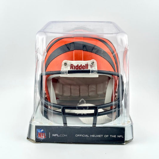 Miniature football helmet in a clear display case with Riddell and NFL branding on a white background