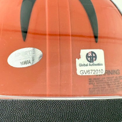 Close-up of authentication stickers on back of orange helmet. 