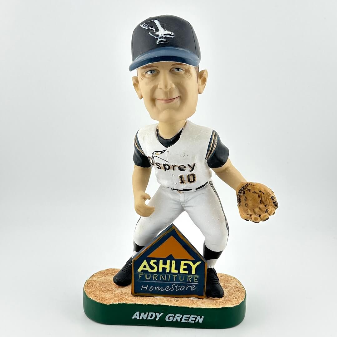 Bobblehead of a baseball player with a branded base on a white background