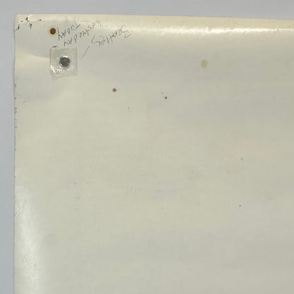 Close up of back, top, left corner of poster with pen handwriting and brown spots. 