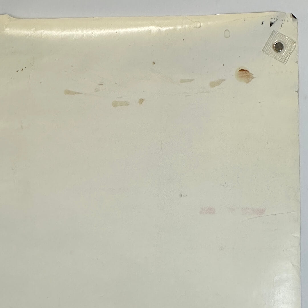 Back, top right corner with brown smudges and rolled corner. 