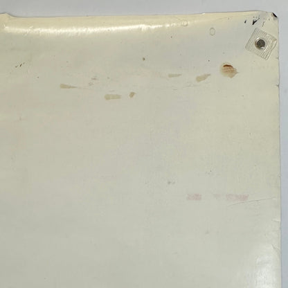 Back, top right corner with brown smudges and rolled corner. 