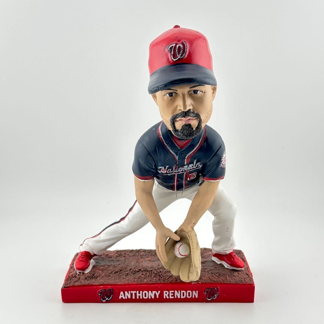 Bobblehead of a baseball player in a blue and red uniform with a red cap on a white background