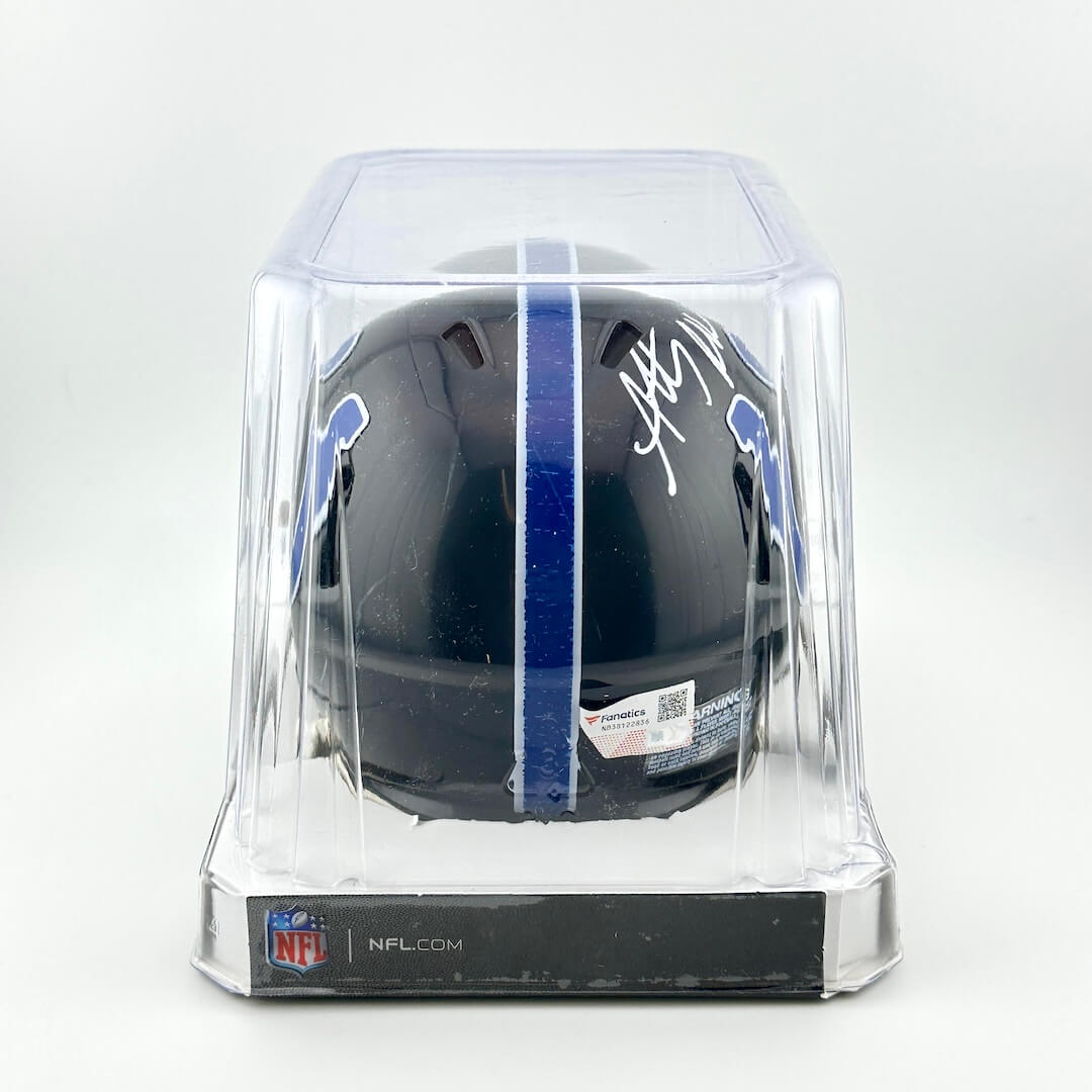 Black football helmet with autograph in a clear display case on a white background