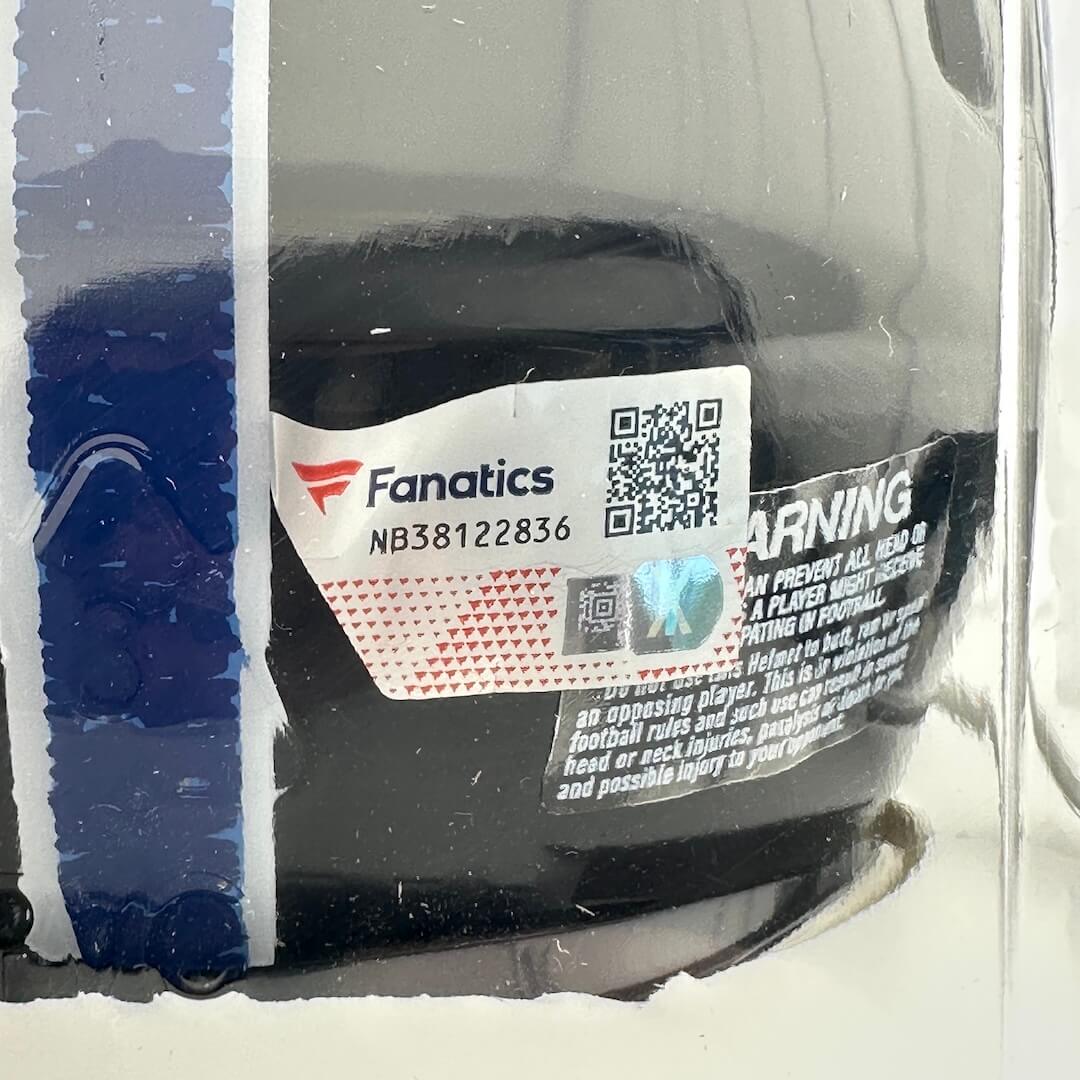 Black helmet with Fanatics branding and a QR code, inside a clear plastic packaging.