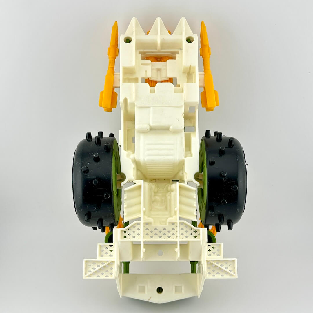 Toy car chassis with black wheels and orange suspension on a gray background