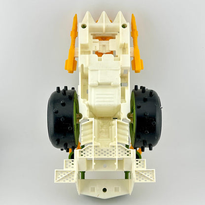 Toy car chassis with black wheels and orange suspension on a gray background