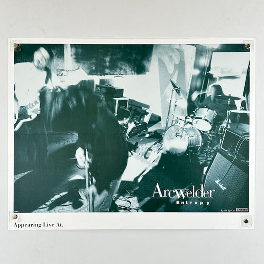 Black and white photo of a band performing with 'Arcwelder Entropy' branding.