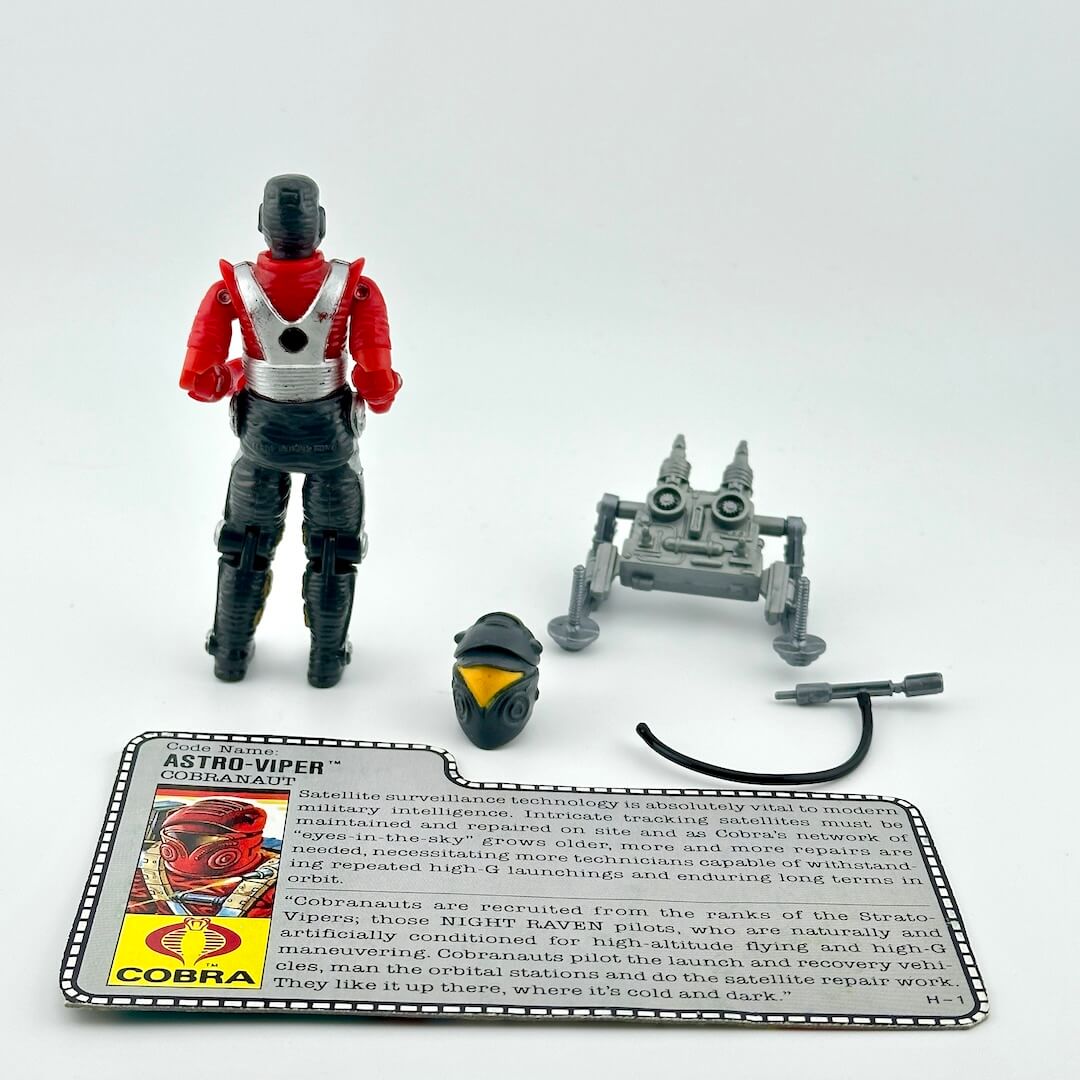 G.I. Joe action figure with accessories and character card against white background.