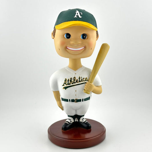 Bobblehead figure of a baseball player in an Athletics uniform with a bat on a white background