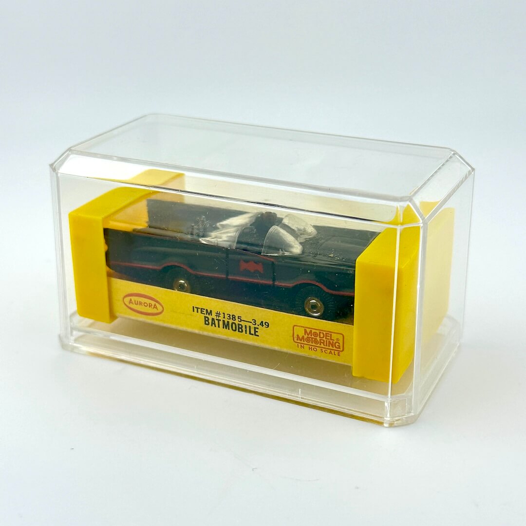 Model car in a clear and yellow box on a white background