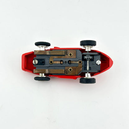 Underside of slot car on white background. 