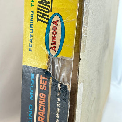 Close-up of a vintage Aurora model racing set packaging with visible wear.