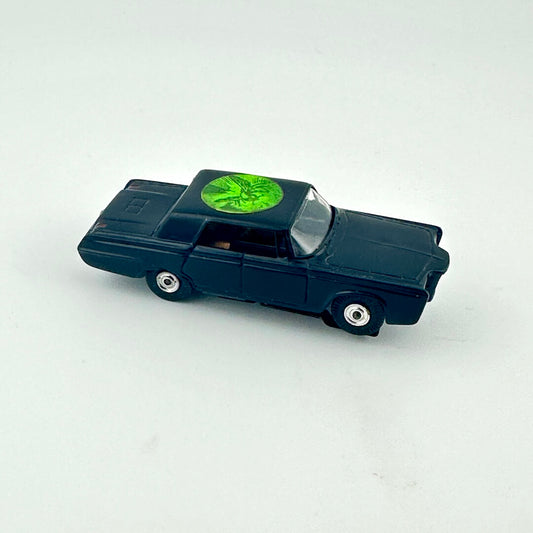 Toy car with a green circular object on top against a white background