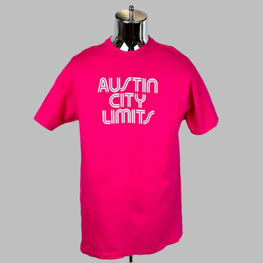 Pink crew neck, short sleeved shirt with "Austin City Limits" print in white across chest. 