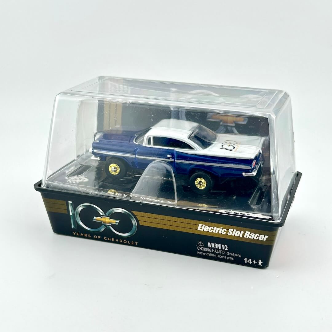 Model car in a clear plastic display case with Chevrolet branding on a white background