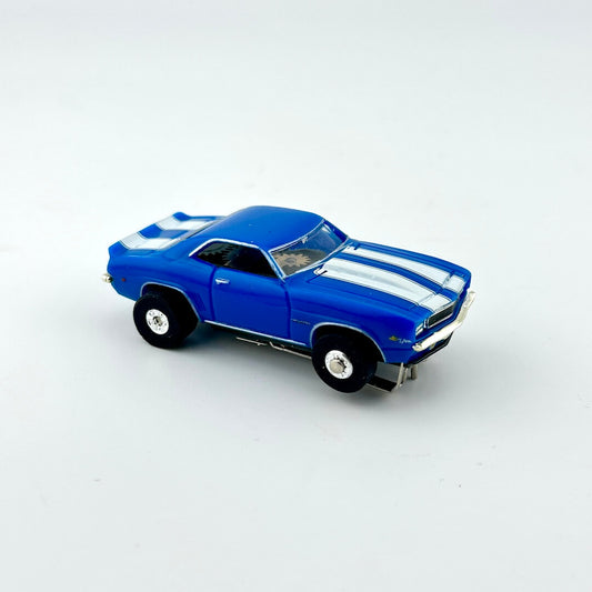 Blue model car with white stripes on a light gray background