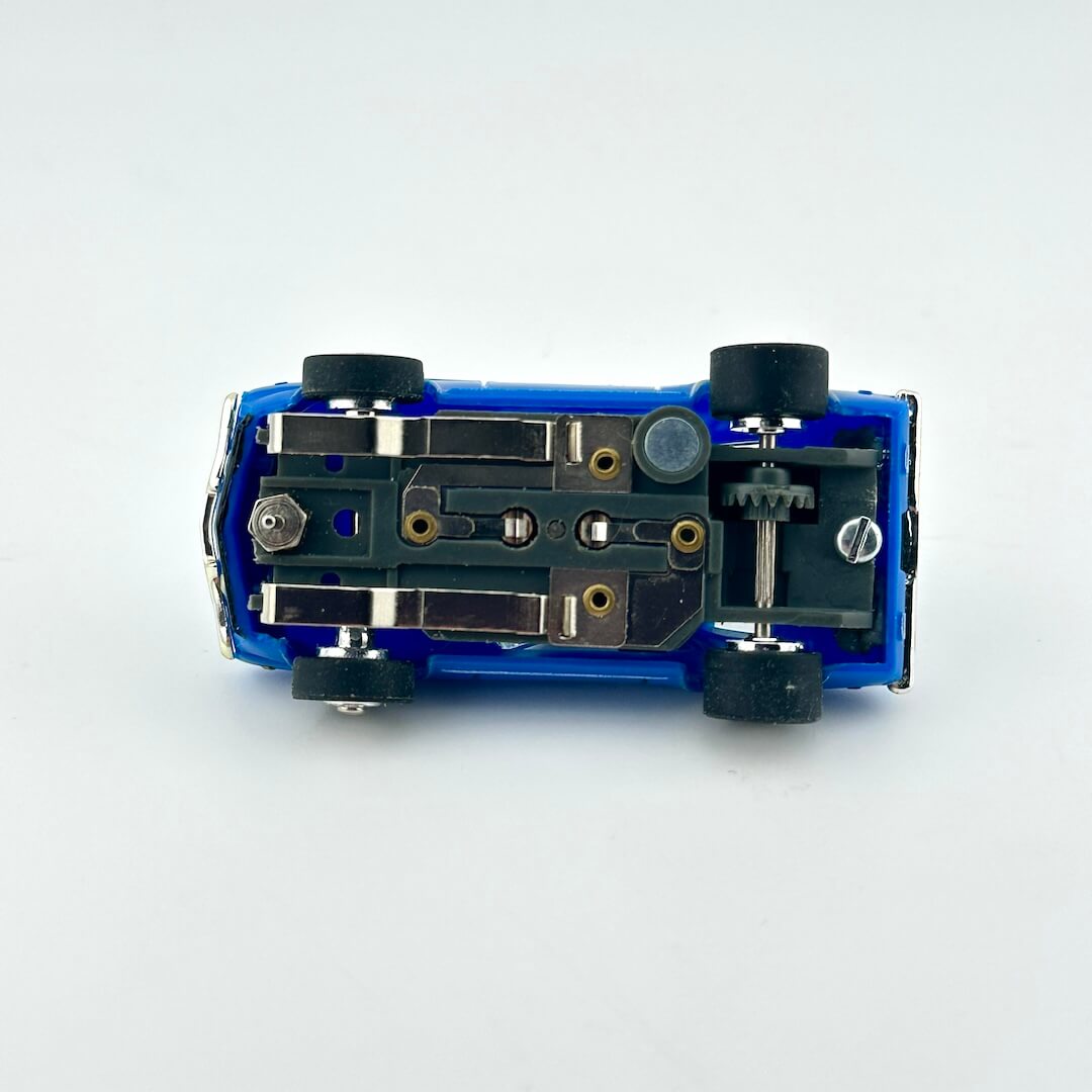 Close-up of a blue model car chassis on a white background